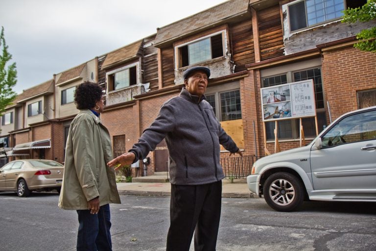 Gerald Renfrow and his wife Connie have stayed on the block despite many of their neighbors taking buyouts from the the city and are looking forward to more activity. (Kimberly Paynter/WHYY)