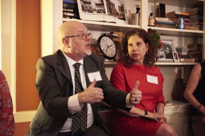 Jose Benitez, President of Safehouse and Executive Director of Prevention Point Philadelphia, speaks during the Friends of Safehouse event. Beside him is Ronda Goldfein, Vice President of Safehouse. (Natalie Piserchio for WHYY)