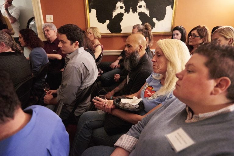 A group of doctors, lawers, friends, and family gather at the home of Marissa Perrone and Joe Piscitello, where they host the Friends of Safehouse event on Friday, May 10, 2019. (Natalie Piserchio for WHYY)