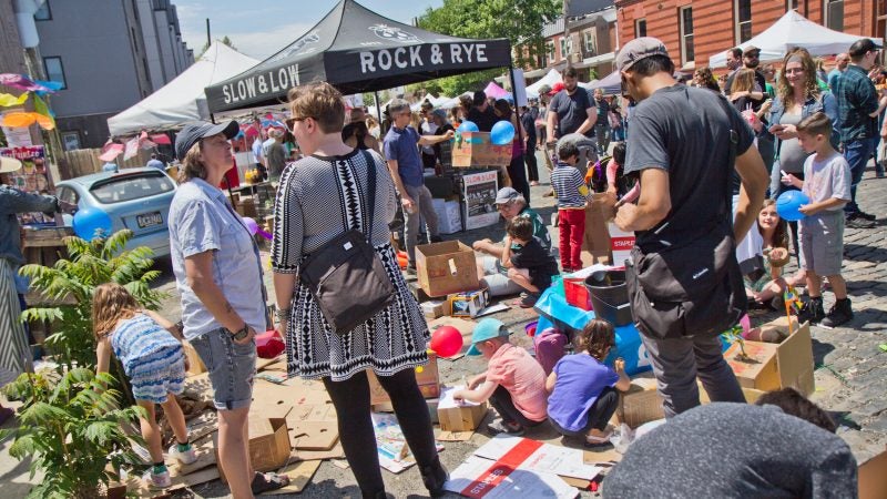 In the spirit of the derby, kids craft with cardboard at the Trenton Avenue Arts festival. (Kimberly Paynter/WHYY)