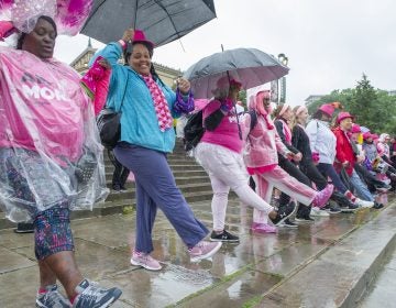 Breast cancer survivors dance on the steps of the Philadelphia Museum of Art. (Jonathan Wilson for WHYY)