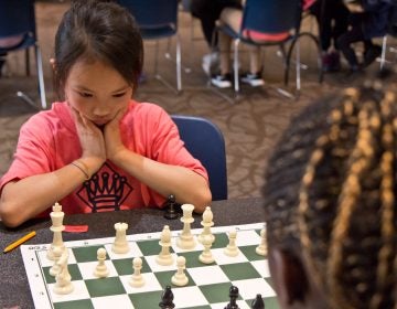 Sharon Suardi, 8, contemplates her next move at the ASAP Philly Girls Play Chess tournament. (Kimberly Paynter/WHYY)