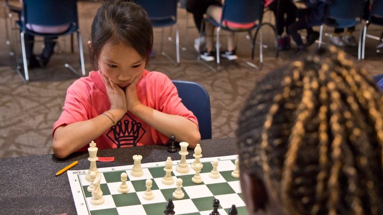 woman studying the next chess move, Stock image