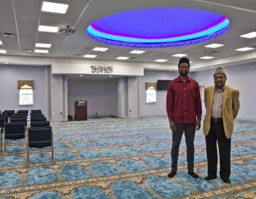 Imam Abdullah Dibba (left) and Mujeeb Choudhary (right) in the men’s prayer room at the Bait-ul-Aafiyat Mosque in Philadelphia. (Kimberly Paynter/WHYY)