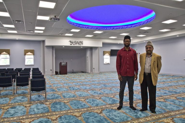 Imam Abdullah Dibba (left) and Mujeeb Choudhary (right) in the men’s prayer room at the Bait-ul-Aafiyat Mosque in Philadelphia. (Kimberly Paynter/WHYY)