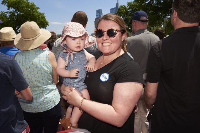 Kara Derstine holds baby Emilie Derstine at Former Vice President Joe Biden's presidential kickoff campaign rally at Eakins Oval in Philadelphia, Pa. (Natalie Piserchio for WHYY)