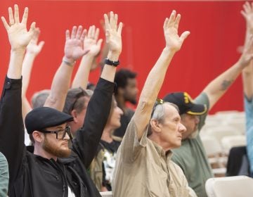 Lieutenance Governor John Fetterman asks the audience who is in favor of the legalization of recreational marijuana and the majority of attendees raise their hands. (Jonathan Wilson for WHYY)