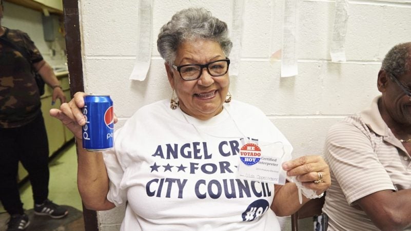 Nilda Oppenheimer, a poll worker and certified interpreter for the city of Philadelphia, enjoys a Pepsi after the 2019 Philadelphia Primary election polls close. (Natalie Piserchio for WHYY)