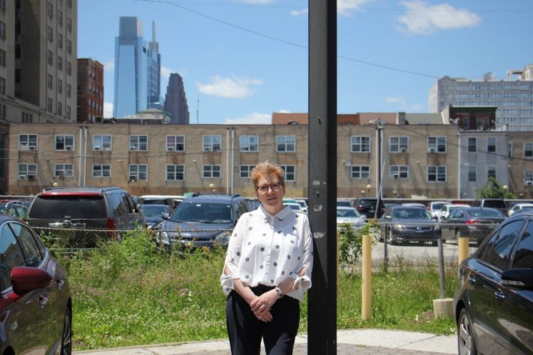 Jessica Hilburn-Holmes, Executive Director of the Philadelphia Bar Foundation, stands near the site at 8th and Race streets in Chinatown that will be the Equal Justice Center. (Emma Lee/WHYY)