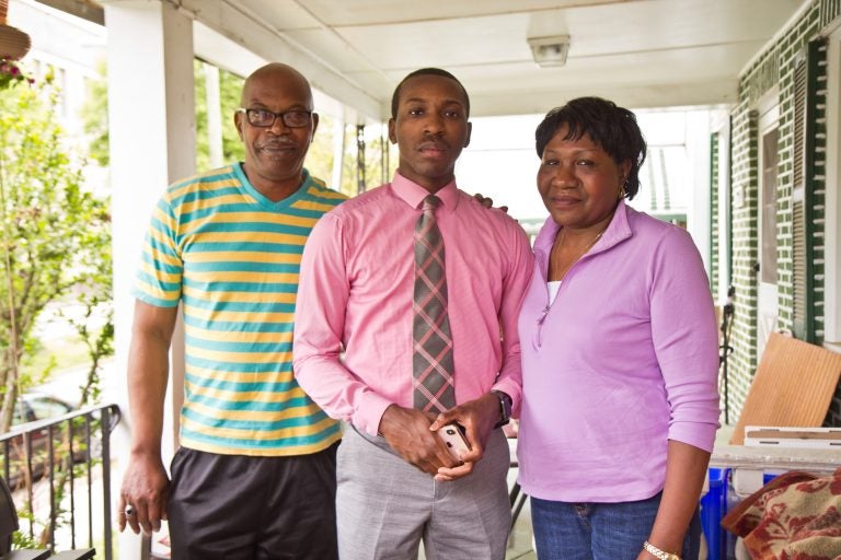 William Bess, 19, (center) with his mother and father on their porch in East Mt. Airy. (Kimberly Paynter/WHYY)