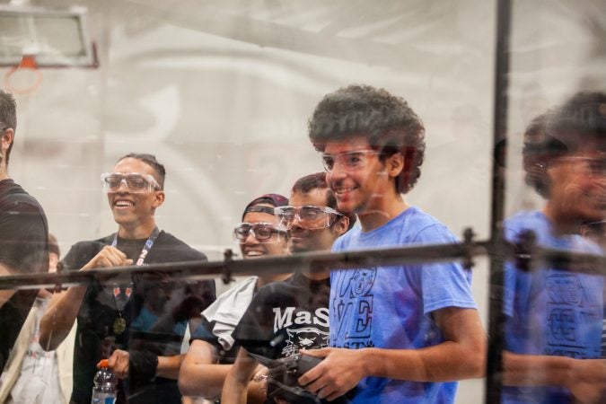 Students from MaST Community Charter School watch their robot Mcnasty compete against Trenton High School's robot Gary Saturday during the Liberty Bots competition. (Brad Larrison for WHYY)