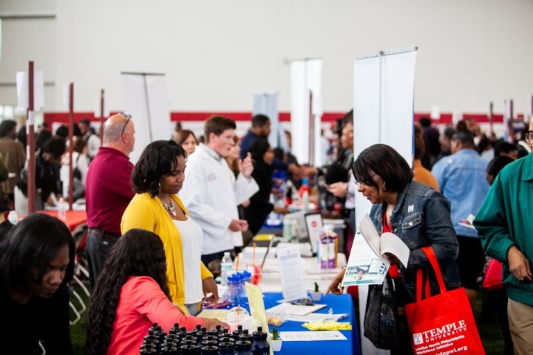 Job seeking Philadelphians spoke with employers from around the region Thursday morning at the 13th annual Neighborhood Job Fair at Temple University. (Brad Larrison for WHYY)