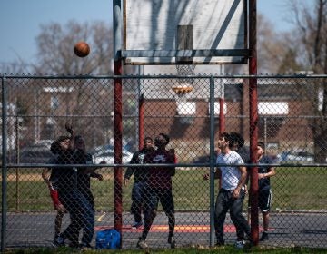 A group of boys play a game of basketball at Vogt park in Mayfair on Saturday, April 6, 2019. (Kriston Jae Bethel for WHYY)