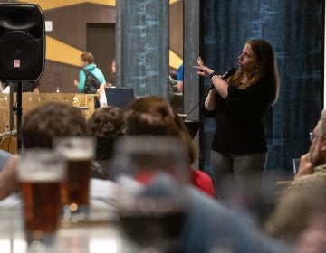 Jessica Choppin Roney, associate professor of history at Temple University, lectures on colonial-era Philadelphia politics at the Cambria Hotel during the city's first Profs and Pints event. (Kriston Jae Bethel for WHYY)