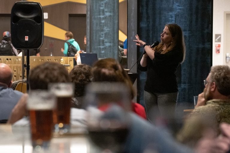 Jessica Choppin Roney, associate professor of history at Temple University, lectures on colonial-era Philadelphia politics at the Cambria Hotel during the city's first Profs and Pints event. (Kriston Jae Bethel for WHYY)