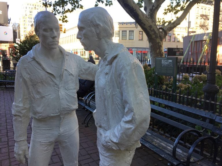 This Oct. 20, 2017 photo shows two figures that are part of the Gay Liberation Monument in Christopher Park across from the Stonewall Inn in Greenwich Village in New York. Riots took place at the Stonewall Inn after a police raid in 1969, and the park was declared a U.S. national monument in 2016 to honor the birthplace of the LGBT rights movement. (AP Photo/Beth J. Harpaz)