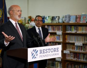 Pennsylvania Gov. Tom Wolf, left, speaks as John H. Taggart School Principal Nelson R. Reyes looks on during a news conference at the school's library, Thursday, March 21, 2019, in Philadelphia. Wolf discussed his infrastructure package, Restore Pennsylvania, to help remediate contaminants from Pennsylvania schools. (Matt Slocum/AP Photo)