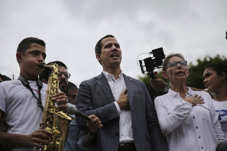 Opposition leader Juan Guaidó and congresswoman Olivia Lozano join in the singing of the national anthem during a rally in Caracas, Venezuela, Saturday, May 11, 2019. Guaidó has called for nationwide marches protesting the Maduro government, demanding new elections and the release of jailed opposition lawmakers. (Rodrigo Abd/AP Photo)