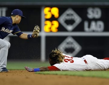 Philadelphia Phillies' Odubel Herrera, right, steals second base past Milwaukee Brewers second baseman Keston Hiura during the second inning of a baseball game, Tuesday, May 14, 2019, in Philadelphia. (AP Photo/Matt Slocum)