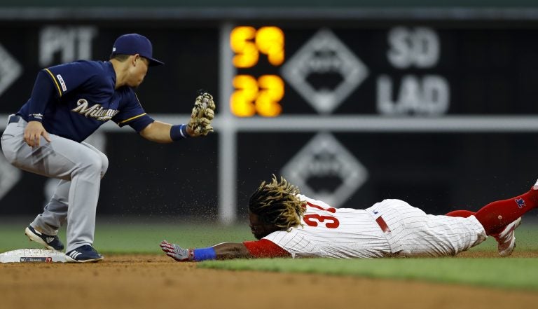 Philadelphia Phillies' Odubel Herrera, right, steals second base past Milwaukee Brewers second baseman Keston Hiura during the second inning of a baseball game, Tuesday, May 14, 2019, in Philadelphia. (AP Photo/Matt Slocum)