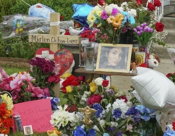 A memorial of flowers, balloons, a cross and photo of victim Marlen Ochoa-Lopez, are displayed on the lawn, Friday, May 17, 2019 in Chicago, outside the home where Ochoa-Lopez was murdered last month. Assistant State's Attorney James Murphy says a pregnant Ochoa-Lopez, who was killed and whose baby was cut from her womb, was strangled while being shown a photo album of the late son and brother of her attackers. (Teresa Crawford/AP Photo)