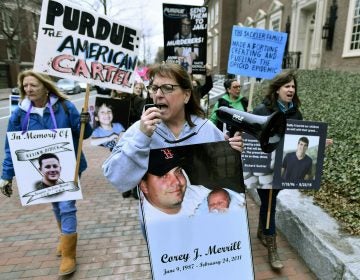 In this Friday, April 12, 2019, file photo, Cheryl Juaire of Marlborough, Mass., (center), leads protesters near the Arthur M. Sackler Museum at Harvard University in Cambridge, Mass. Juaire, whose son was addicted to opioids and died of a heroin overdose in 2011, led the demonstration by parents who’ve lost children in the addiction epidemic. They want the Sackler family name removed from the building at Harvard. In New York, there’s a Sackler Wing at The Metropolitan Museum of Art and a Sackler Center for Arts Education at The Guggenheim. There’s a Sackler Room at the National Gallery in London, a Sackler Wing of Oriental Antiquities at the Louvre. (Josh Reynolds/AP Photo)