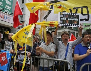 Pro-Beijing supporters destroy yellow umbrellas, used to mark protesting denouncing far-reaching Beijing control, during a demonstration in Hong Kong, Sunday, May 26, 2019. A vigil will be held on June 4 at the Victoria Park to mark the 30th anniversary of the military crackdown on the pro-democracy movement at Beijing's Tiananmen Square on June 4, 1989. (Kin Cheung/AP Photo)