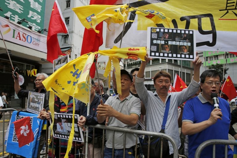 Pro-Beijing supporters destroy yellow umbrellas, used to mark protesting denouncing far-reaching Beijing control, during a demonstration in Hong Kong, Sunday, May 26, 2019. A vigil will be held on June 4 at the Victoria Park to mark the 30th anniversary of the military crackdown on the pro-democracy movement at Beijing's Tiananmen Square on June 4, 1989. (Kin Cheung/AP Photo)