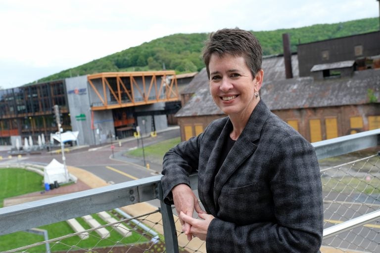 ArtsQuest President and CEO Kassie Hilgert stands on the SteelStacks campus, which sits at the base of the former blast furnaces of Bethlehem Steel. (Matt Smith for Keystone Crossroads)