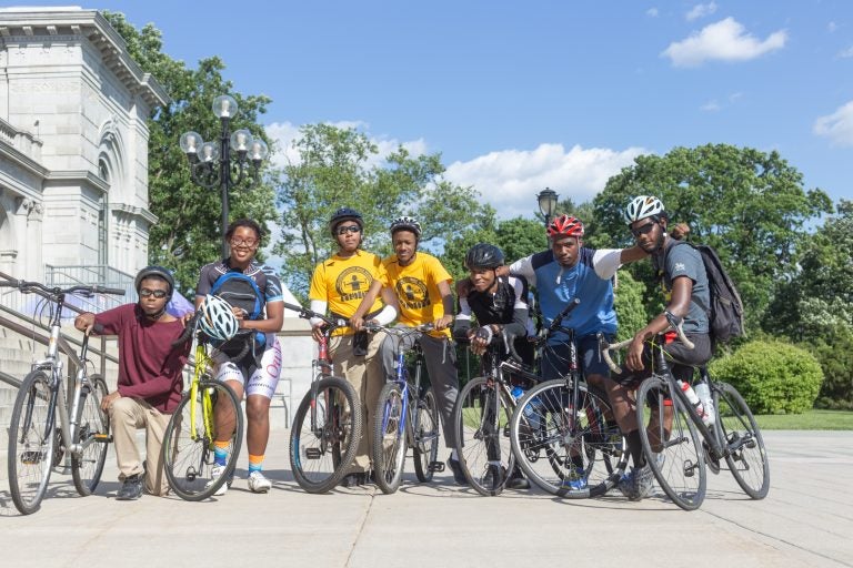 Members of the National Youth Bike Council pose at the Please Touch Museum before a group ride through Fairmount Park. (Angela Gervasi for WHYY)