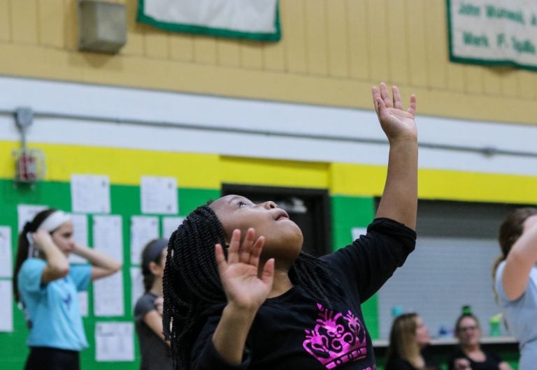 Faith Green practices setting volleyballs at a sports clinic through Philly Girls in Motion. (Angela Gervasi for WHYY)