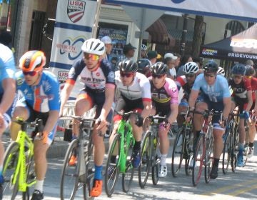 A group of cyclists race on a street in Wilmington.