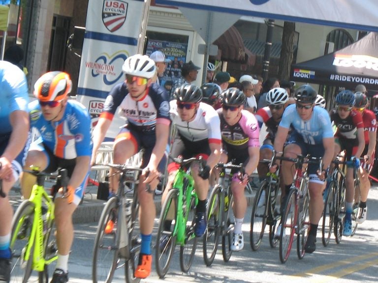 A group of cyclists race on a street in Wilmington.