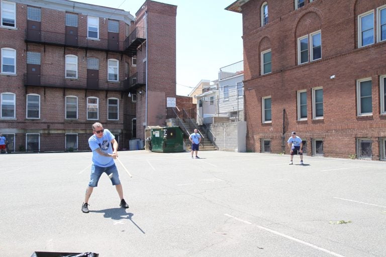 Two teams battle it out to advance to the next round of the 10th Annual John Marzano Half Ball Tournament. (Ximena Conde/WHYY)