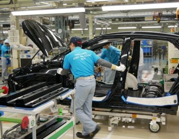 Workers push a partly assembled Mirai through the assembly line at Toyota's LFA Works in Aichi Prefecture, Japan. Since there are so few hydrogen fuel cell cars manufactured, all of them are assembled by hand. (Hiroo Saso)