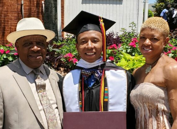 Morehouse grad Ahmad Smith, flanked by his father, Wayne, and his sister Chanel, had $110,000 in student loans wiped clean. (Courtesy of Chanel Smith)