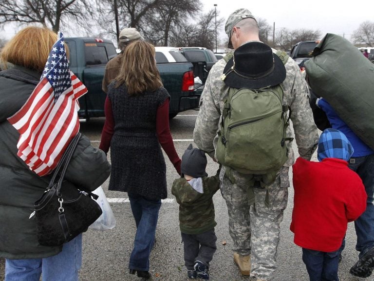 In this Dec. 24, 2011 file photo, a soldier walks with his family following a ceremony at Fort Hood, Texas, for soldiers from the U.S. Army 1st Cavalry 3rd Brigade, who returned home from deployment in Iraq. (Erich Schlegel/AP)