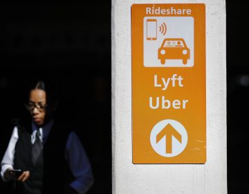 A sign directs Lyft and Uber riders to a designated pickup location at Hartsfield-Jackson Atlanta International Airport in Atlanta. (David Goldman/AP Photo)