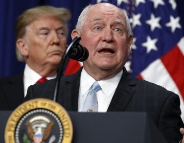 President Trump listens to Agriculture Secretary Sonny Perdue during a signing ceremony. The USDA wants to move two vital research agencies out of Washington D.C. (Jacquelyn Martin/AP)