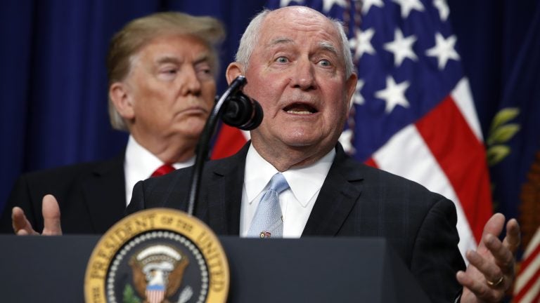 President Trump listens to Agriculture Secretary Sonny Perdue during a signing ceremony. The USDA wants to move two vital research agencies out of Washington D.C. (Jacquelyn Martin/AP)