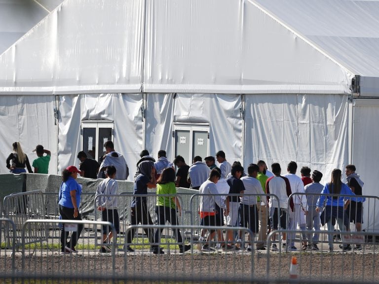 Children line up to enter a tent at the Homestead Temporary Shelter for Unaccompanied Children in Homestead, Fla., in February. (Wilfredo Lee/AP)