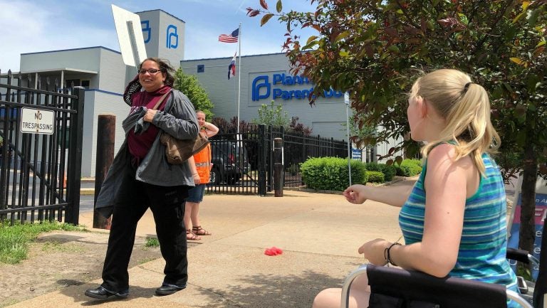 Teresa Pettis (right), an abortion opponent, protests outside the Planned Parenthood clinic in St. Louis, on May 17. Unless a judge intervenes, health officials will force a Missouri facility to stop offering the procedure this week. (Jim Salter/AP)