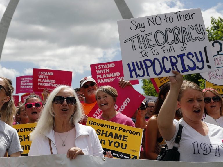 Abortion-rights supporters take part in a protest in St. Louis.The Planned Parenthood clinic in the area will stay open while its legal fight with the state continues. Abortion-rights supporters take part in a protest in St. Louis. A St. Louis judge heard an hour of arguments Thursday on Planned Parenthood's request for a temporary restraining order that would prohibit the state from allowing the license for Missouri's only abortion clinic to lapse at midnight Friday. (Jeff Roberson/AP Photo)