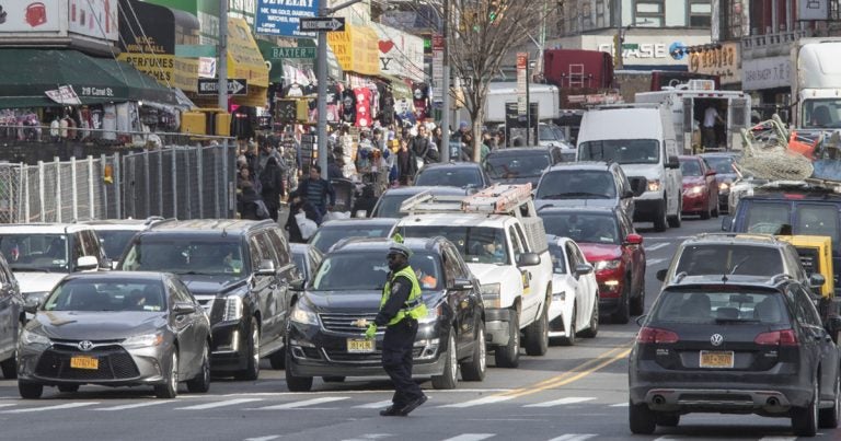 A police officer directs rush hour traffic on Canal Street in New York