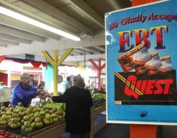 A sign announces the acceptance of electronic benefit transfer cards at a farmers market in California. (Rich Pedroncelli/AP)