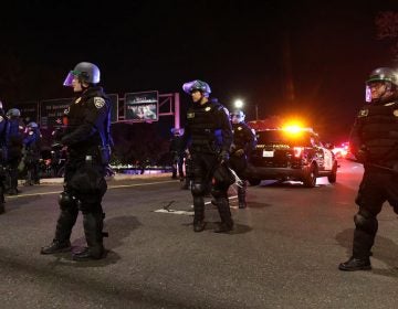 California Highway Patrol officers block an interstate entrance as protesters march. Police use of deadly force became a focus for advocates in California after the district attorney declined to prosecute the officers who fatally shot Stephon Clark, an unarmed black man whose death sparked demonstrations in the state and across the country (Justin Sullivan/Getty Images)