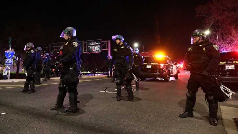 California Highway Patrol officers block an interstate entrance as protesters march. Police use of deadly force became a focus for advocates in California after the district attorney declined to prosecute the officers who fatally shot Stephon Clark, an unarmed black man whose death sparked demonstrations in the state and across the country (Justin Sullivan/Getty Images)