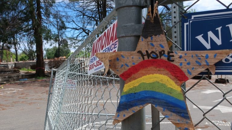 A homemade sign hangs on the fence surrounded Paradise Elementary School. The school was destroyed by the fire and the rubble is now being bulldozed and cleaned up. A homemade sign hangs on the fence surrounded Paradise Elementary School. The school was destroyed by the fire and the rubble is now being bulldozed and cleaned up.
(Michelle Wiley/KQED)