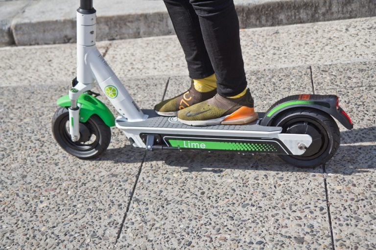 Riders were invited to test drive the Lime scooter at City Hall in Philadelphia. (Kimberly Paynter/WHYY)