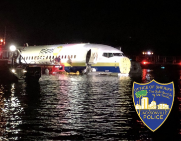 A plane arriving in Jacksonville, Fla., skidded into the St. Johns River on Friday night. (Jacksonville Sheriff's Office, via Twitter)